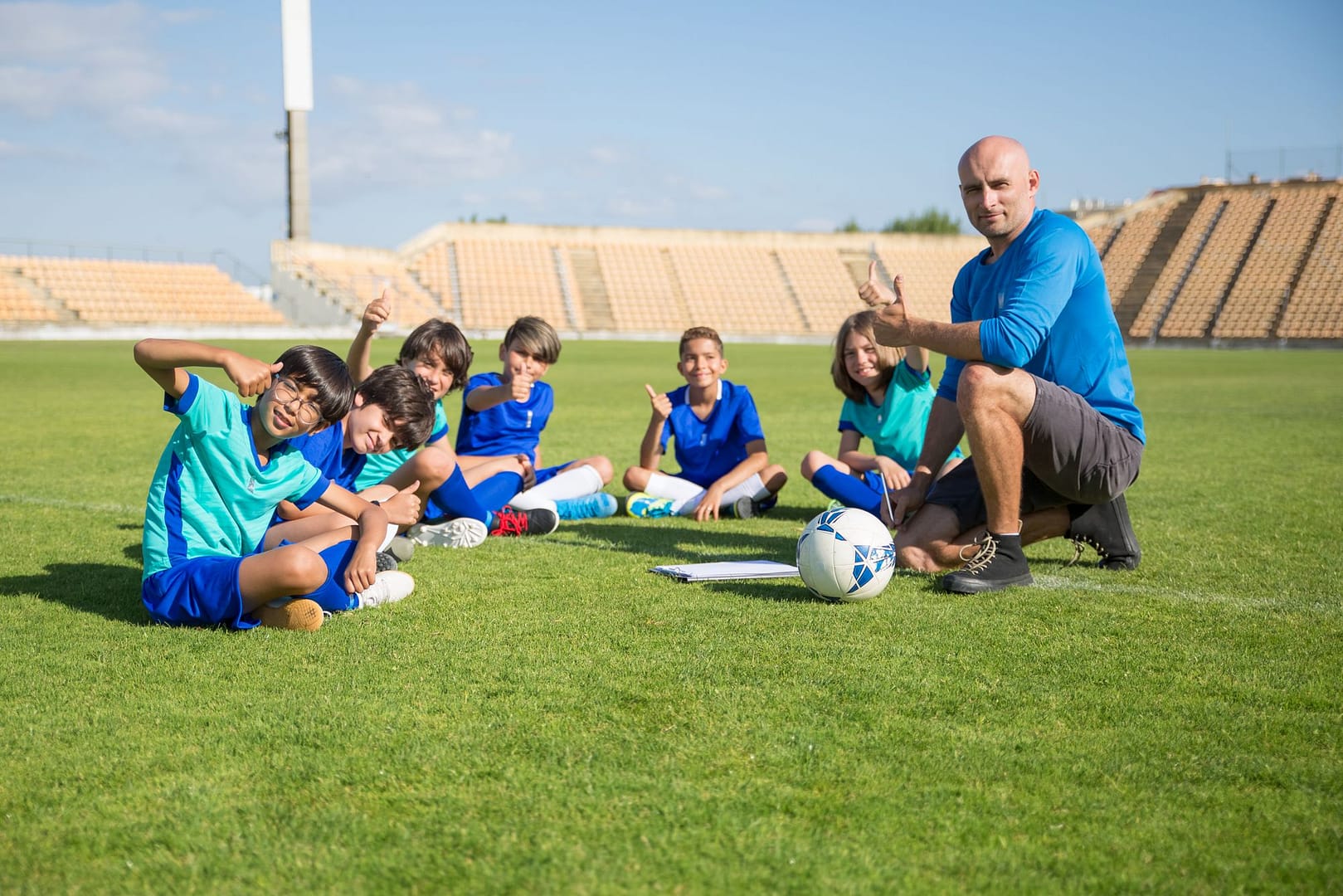 Children enjoying football training with their coach
