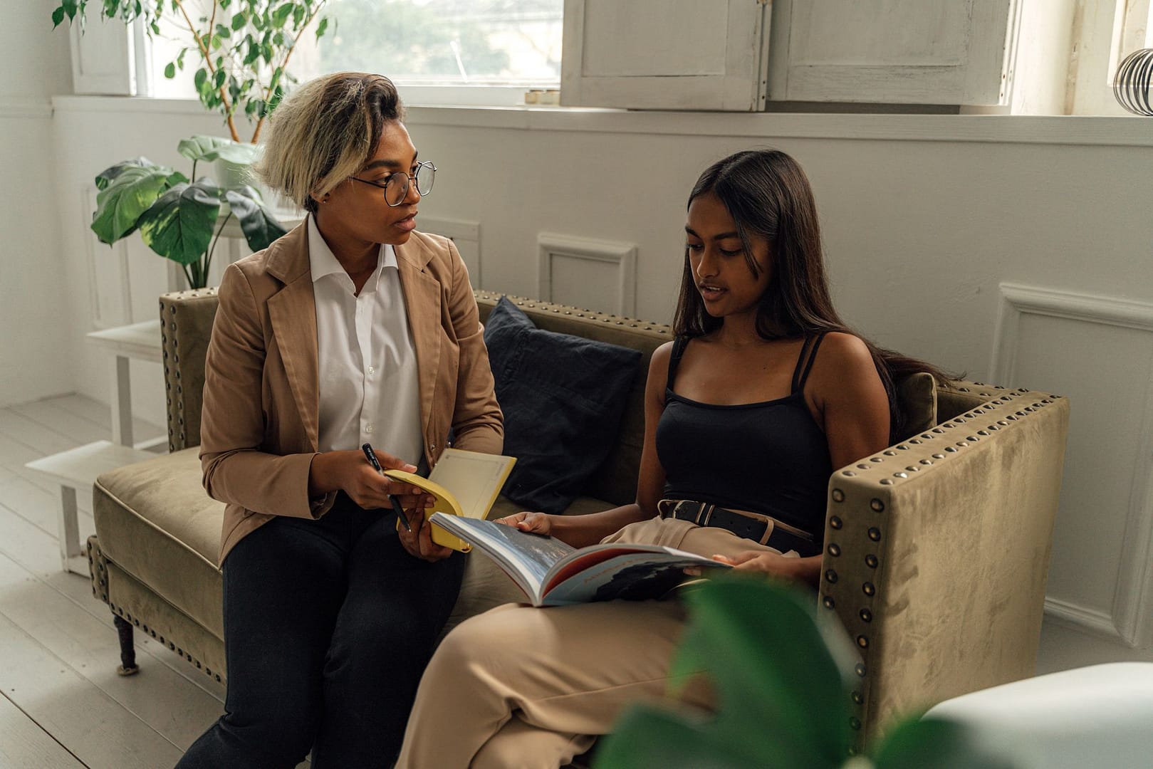 Teacher and student discussing a book together
