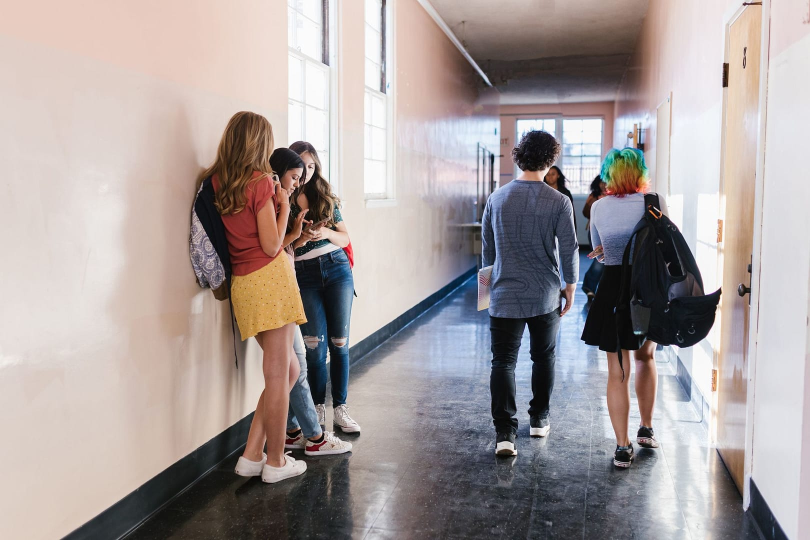 Secondary school students walking along a school corridor