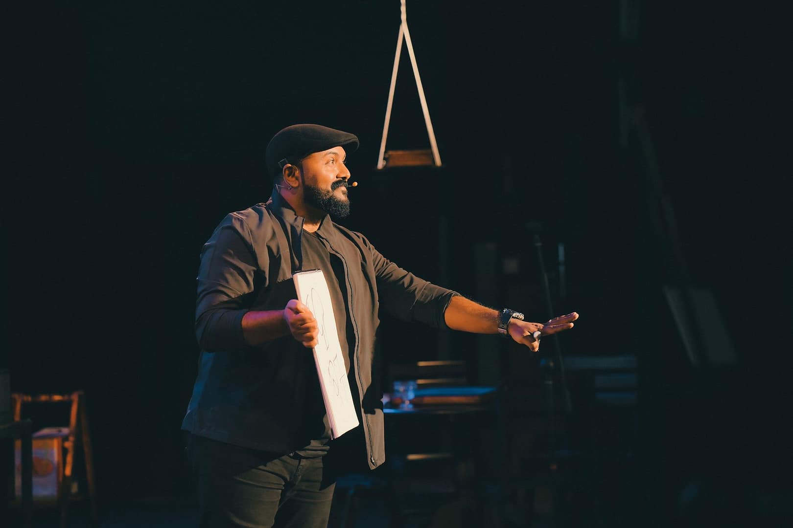 Speaker presenting passionately on stage with a microphone