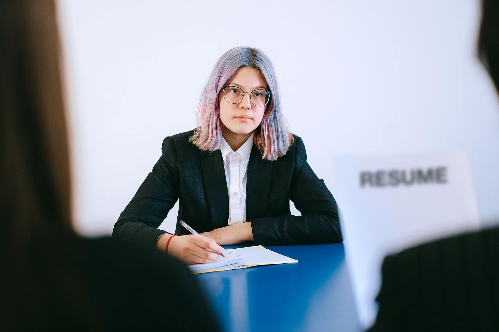 Young woman taking notes during a job interview