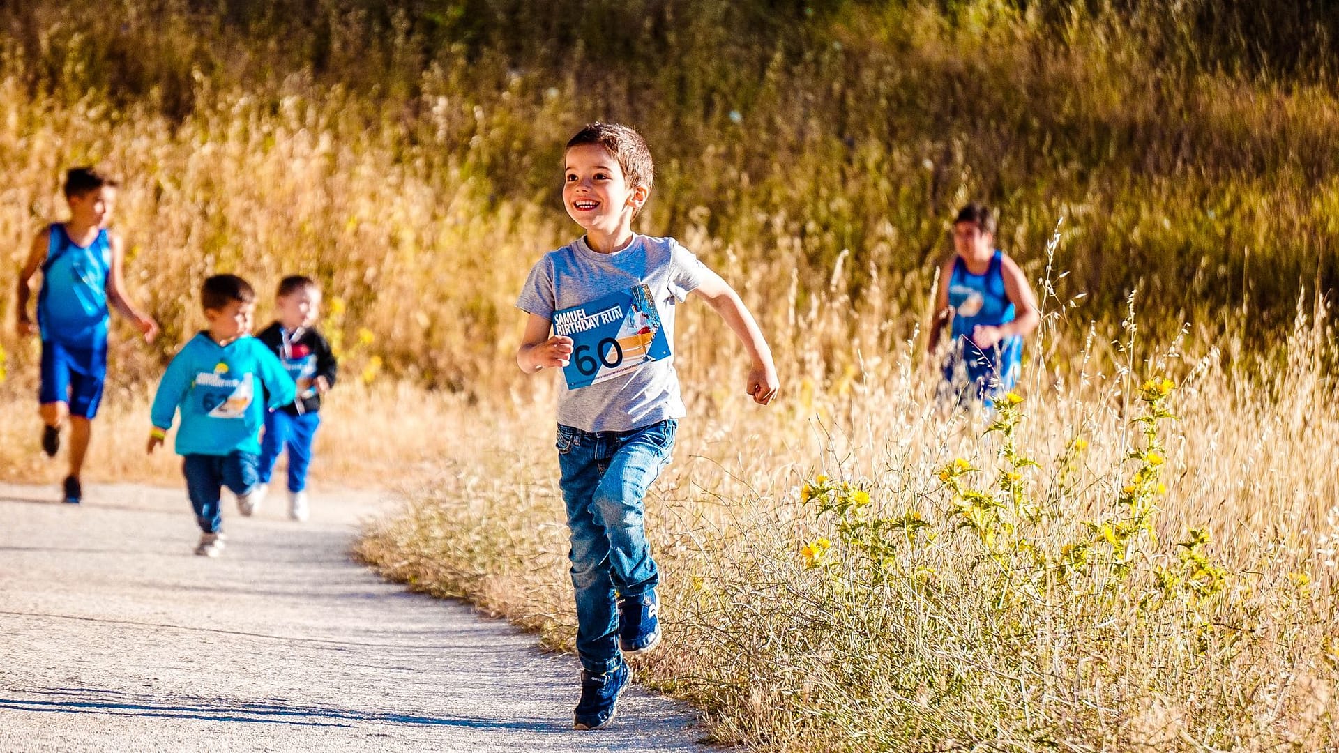 Children running happily in a park race